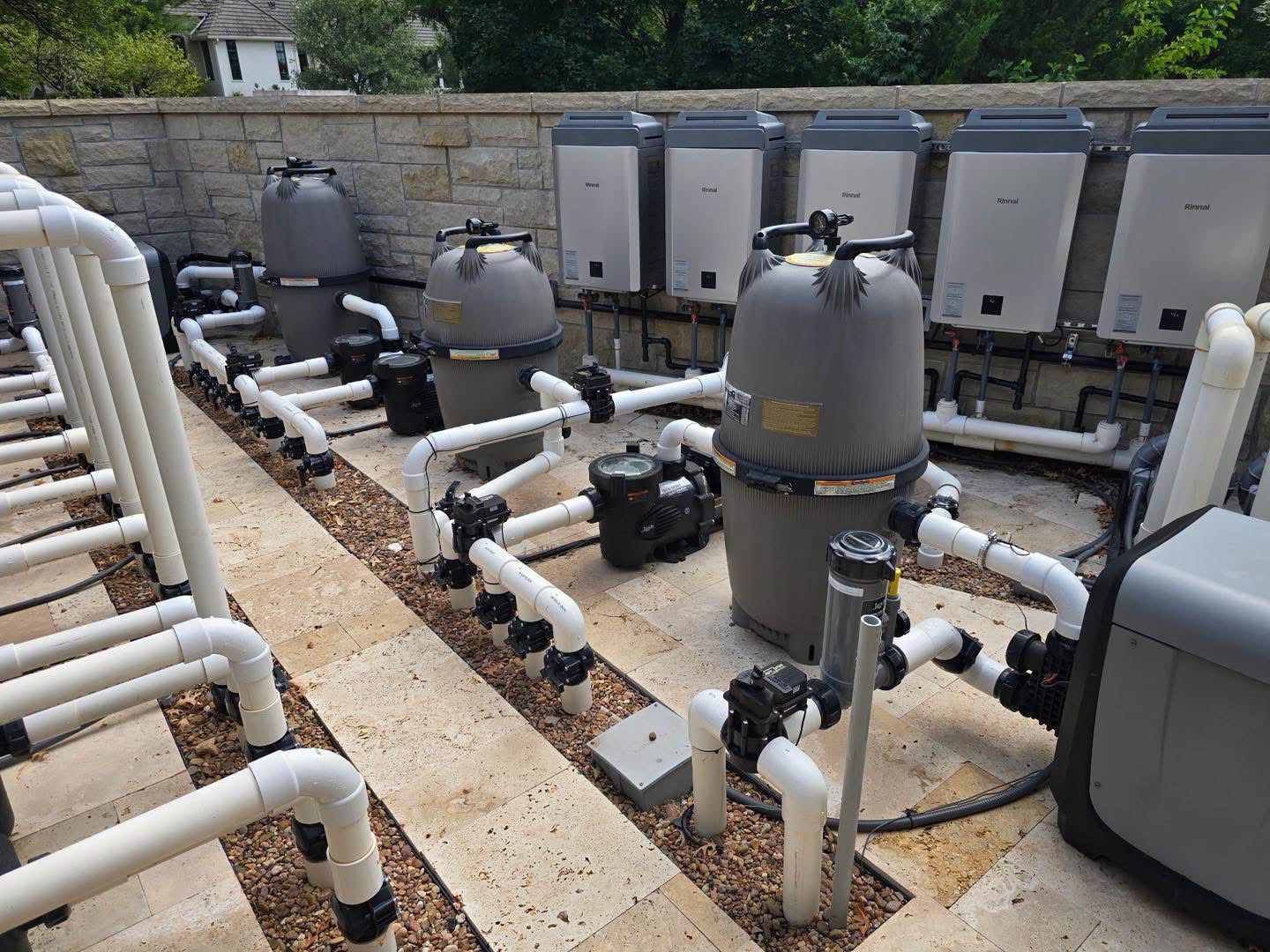 Rocket City Water Wizards technician inspecting high-pressure pool filtration hardware on a finished equipment pad