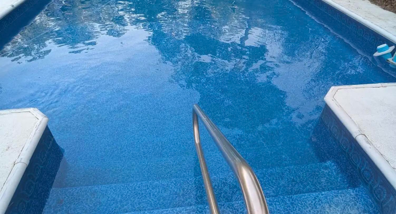 After: renovated pool with new liner, clear balanced water and clean steps