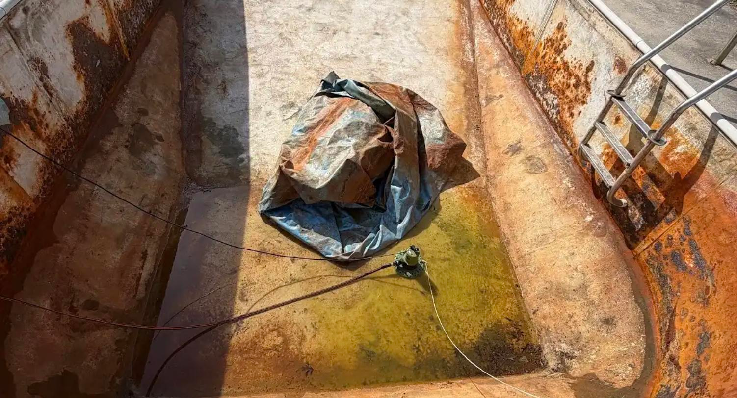 Before: abandoned pool with failed liner, corroded walls and standing groundwater