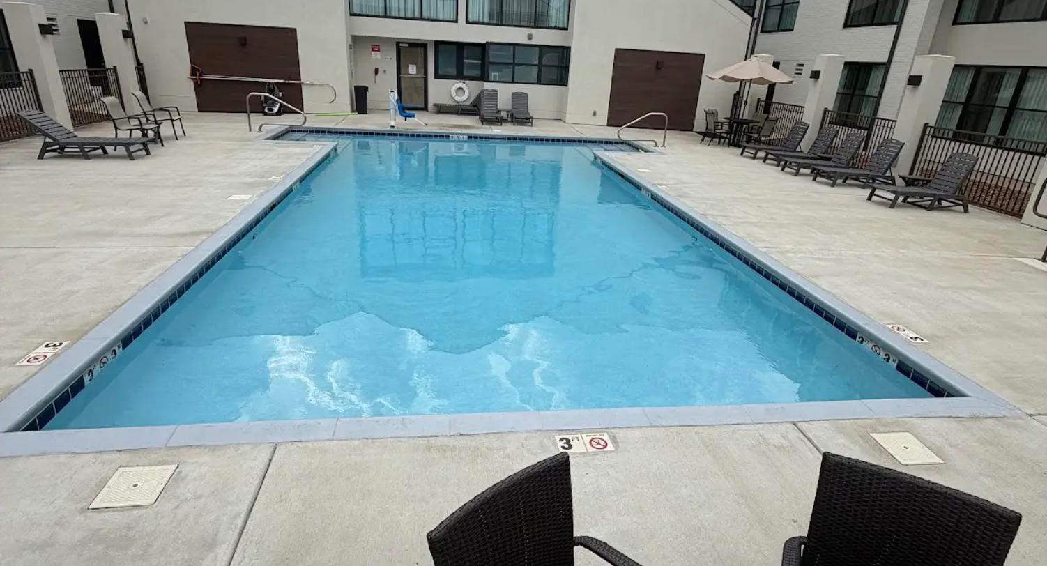 Commercial courtyard pool with clear water under professional maintenance