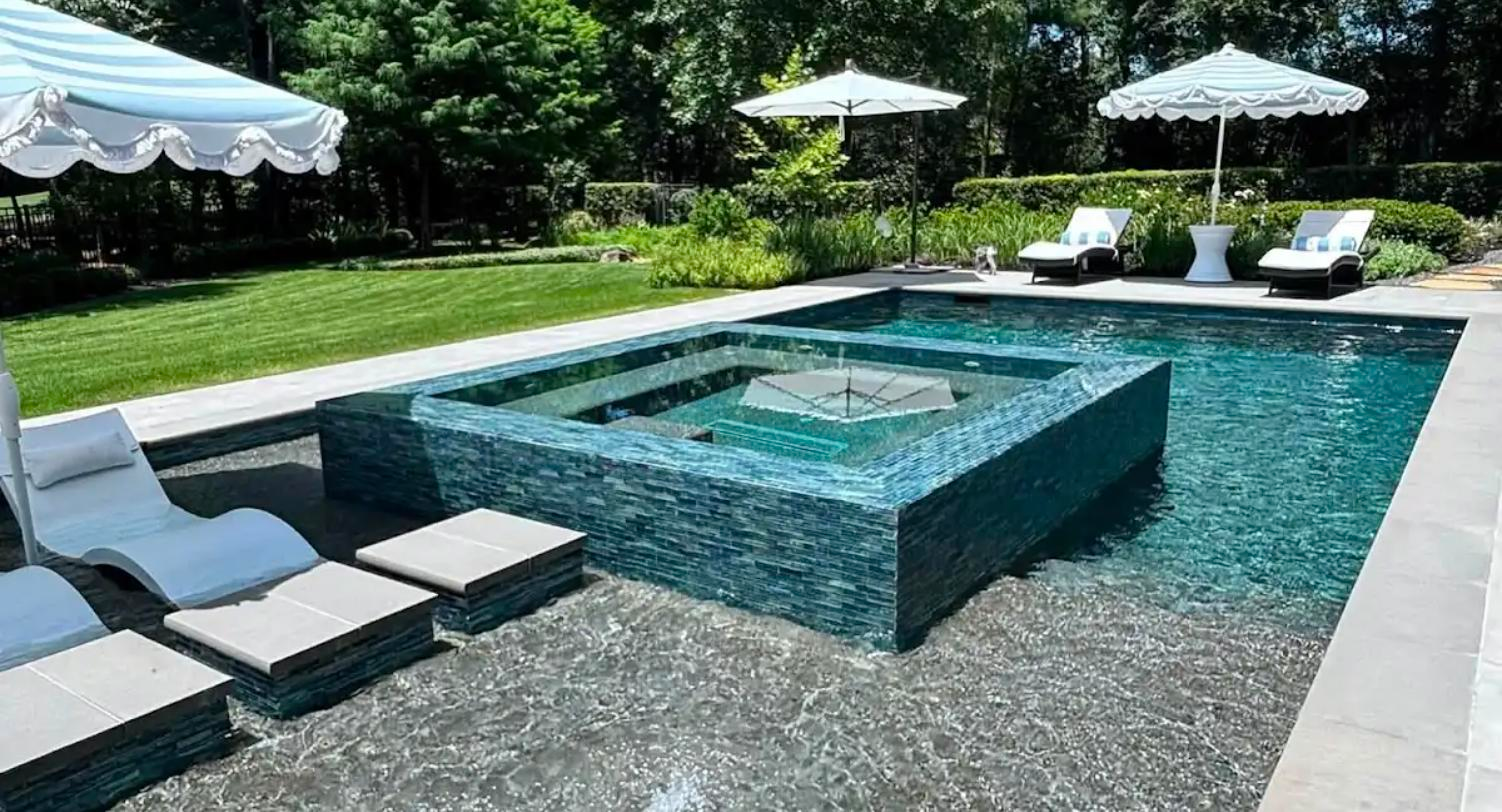 Custom gunite pool with glass-tile raised spa and perimeter overflow built by Rocket City Water Wizards near Huntsville, Alabama