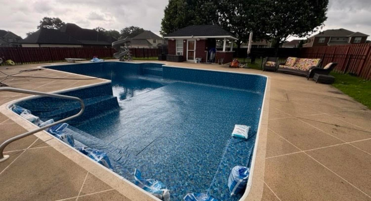 New vinyl liner set and weighted during installation on a renovated pool